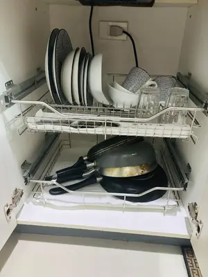 a refrigerator filled with plates and dishes on a shelf at Affordable Staycation At Sea Residence Near Moa By Dona Flores in Manila