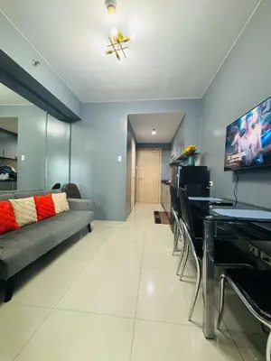 a living room with a couch and a table at Affordable Staycation At Sea Residence Near Moa By Dona Flores in Manila