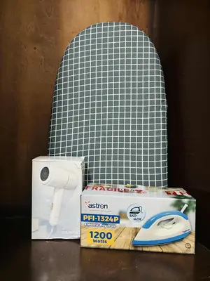 a chair with a pair of scissors and a box at Affordable Staycation At Sea Residence Near Moa By Dona Flores in Manila