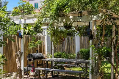 a garden with a bench and a fence at Cozy Las Pinas Haven with Big Garden, Pet Friendly - Near Super Market and the Airport in Manila