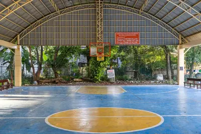a basketball court in a pavilion with a basketball hoop at Cozy Las Pinas Haven with Big Garden, Pet Friendly - Near Super Market and the Airport in Manila