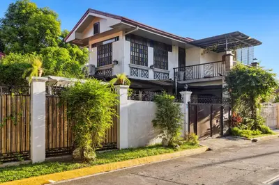 a house with a fence in front of it at Cozy Las Pinas Haven with Big Garden, Pet Friendly - Near Super Market and the Airport in Manila