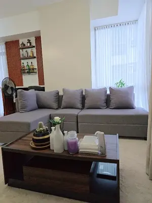 a living room with a couch and a coffee table at Cozy 2BR 2BA 2 Balconies Manhattan Heights Cubao in Manila