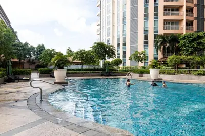 a group of people in a swimming pool in a building at King Bed, Washer, Air Dry, Sauna, Gym & Pool Access, FAST Wi-Fi, Elegant Studio, Near Venice Grand Canal Mall, Walking Distance Britsh Embassy, 5 min drive to BGC, 10 min drive to Manila Airport NAIA 3 in Manila