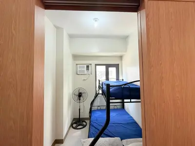 a small room with two bunk beds in it at SMDC Bloom residence Sucat Stunning 2BR in Manila