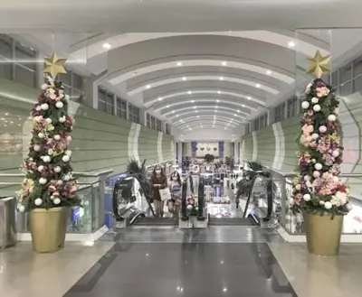 two christmas trees are in a shopping mall at South Residences, Las Piñas in Manila