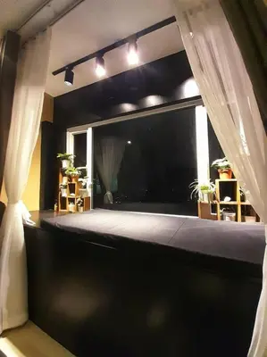 a bedroom with a bed and a window with curtains at South Residences, Las Piñas in Manila