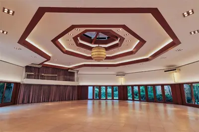 a large ballroom with a ceiling with a light on it at Cozy Home in BGC in Manila