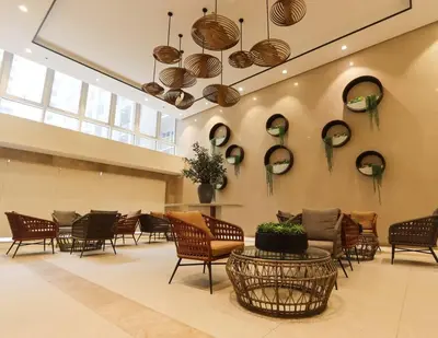 a lobby with chairs and mirrors on the wall at The Room of Requirement in Manila