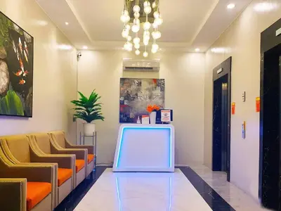 a waiting room with chairs and a table in a building at Condotel 1 Bedroom Across SM Aura in Manila
