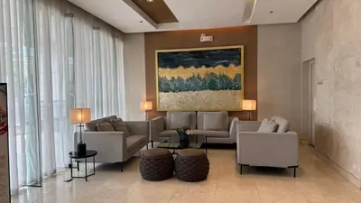 a lobby with couches and chairs and a painting at 2BR Unit in SMDC Shore 3 with pool access in Manila