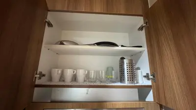 a cabinet with cups and utensils in it at 2BR Unit in SMDC Shore 3 with pool access in Manila