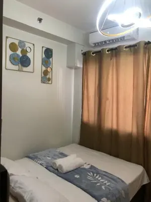 a small room with a bed and a window at TresMaria'Staycation in Manila