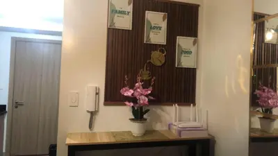 a room with a table with flowers and cards at TresMaria'Staycation in Manila