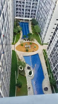 an overhead view of a pool between two tall buildings at TresMaria'Staycation in Manila