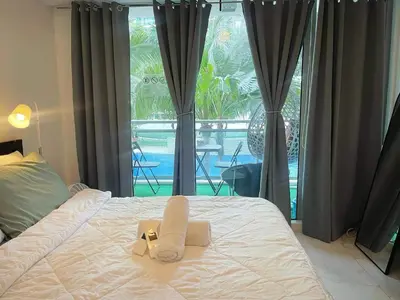 a bed with a ribbon on it with a window at Azure Urban Resort Residences - stayCAOtion in Manila