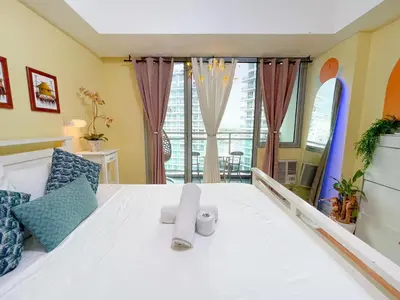 a bedroom with a white bed with towels on it at Azure Urban Resort Residences - stayCAOtion in Manila