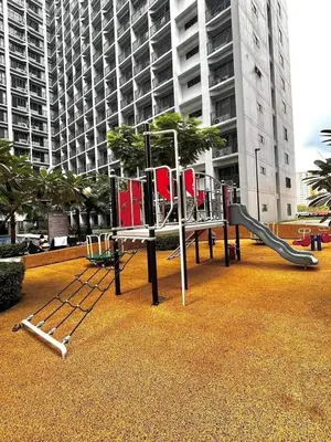 a playground with a slide in front of a building at 19106 Condotel at Shore 2 MOA wNetflix in Manila