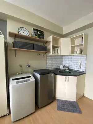 a small kitchen with a sink and a dishwasher at Condo near ATC- Molito Alabang, Muntinlupa in Manila