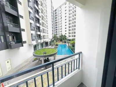 a balcony with a swimming pool in a building at SM HOME Spring Residences Staycation and Condotel in Manila
