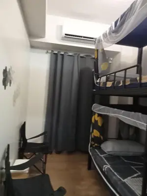 a room with two bunk beds and a window at SM HOME Spring Residences Staycation and Condotel in Manila