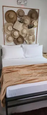 a bedroom with a bed with hats on the wall at Serene Summer close proximity to Araneta Centre in Manila
