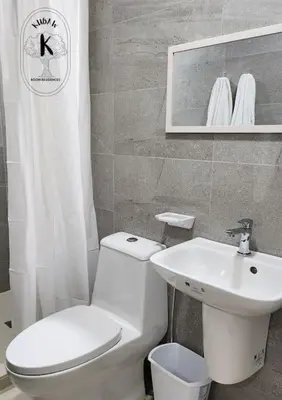 a bathroom with a white toilet and a sink at Serene Summer close proximity to Araneta Centre in Manila