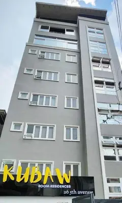 a tall building with a sign on the side of it at Serene Summer close proximity to Araneta Centre in Manila