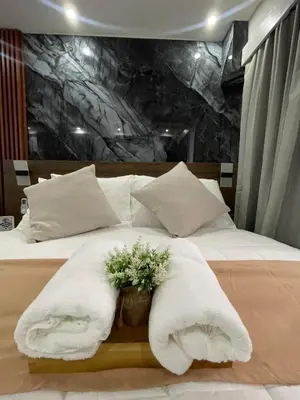 a bedroom with a bed with towels on it at Mitch serene shore in Manila