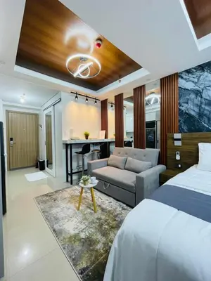 a bedroom with a bed and a couch and a desk at Mitch serene shore in Manila