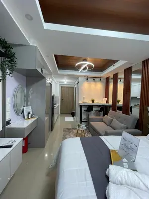a bedroom with a bed and a living room at Mitch serene shore in Manila