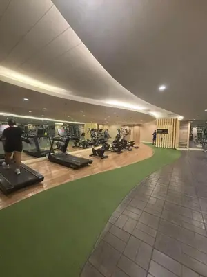 a gym with treadmills and a green carpet at Mitch serene shore in Manila