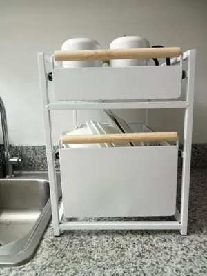a kitchen shelf with utensils on it next to a sink at Spring Residences 2BR R&D Staycation and Condotel in Manila