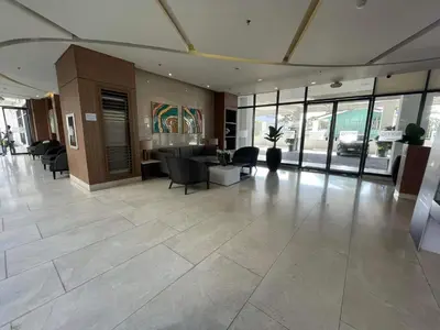 an office lobby with a reception desk and chairs at Spring Residences 2BR R&D Staycation and Condotel in Manila