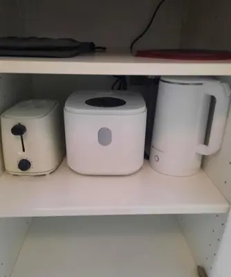 three appliances sitting on a shelf in a kitchen at Chic and Cozy Minimalist Condo with Pool in Makati City in Manila