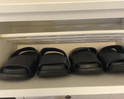 a shelf with black items in a refrigerator at Chic and Cozy Minimalist Condo with Pool in Makati City in Manila
