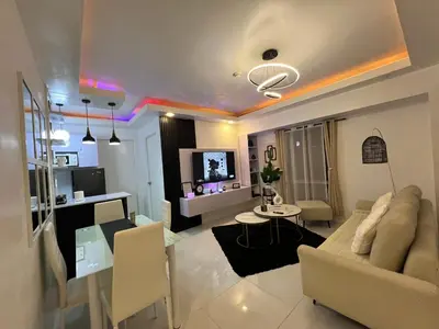 a living room with a couch and a table at Lucky 7 Suites in Manila