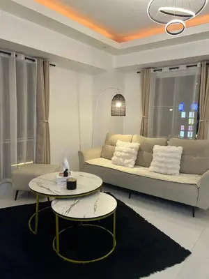 a living room with a couch and a table at Lucky 7 Suites in Manila