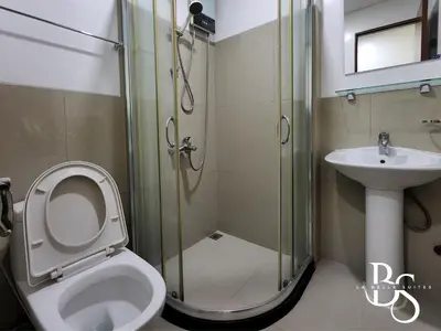 a bathroom with a shower and a toilet and a sink at The Beacon Makati New Renovated Studio Ayala Greenbelt CBD Makati PH in Manila