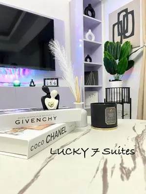 a room with a desk with a tv and a book at LUCKY 7 Suites in Manila