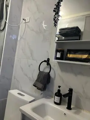 a bathroom with a sink and a mirror at LUCKY 7 Suites in Manila