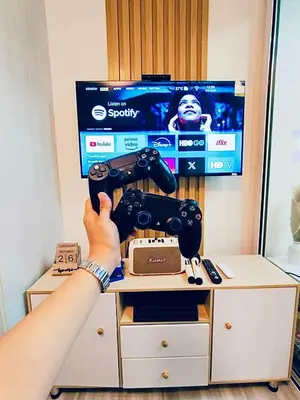 a person holding a video game controller in front of a tv at Oveecation Suites St Tropez Tower in Manila