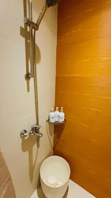a bathroom with a white toilet in a room at Oveecation Suites St Tropez Tower in Manila
