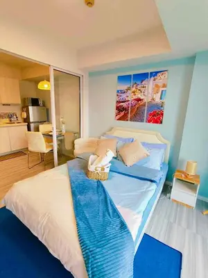 a bedroom with a large bed with a basket on it at Oveecation Suites St Tropez Tower in Manila