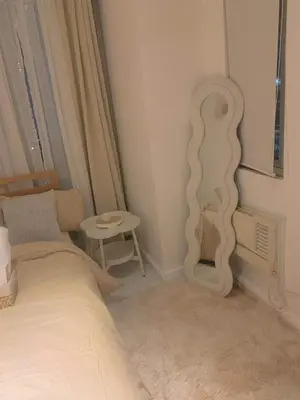 a bedroom with a bed and a mirror on the wall at Oveecation Suites Positano Tower in Manila