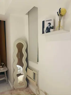 a room with a guitar leaning against a wall at Oveecation Suites Positano Tower in Manila
