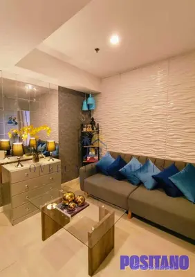 a living room with a couch and a table at Oveecation Suites Positano Smarthome in Manila