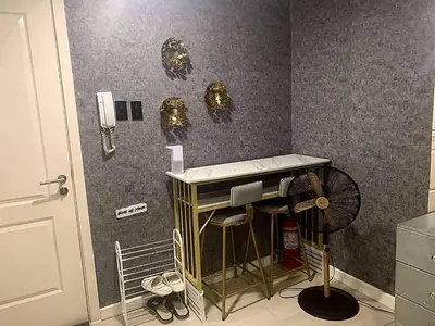 a room with a fan on the wall and a room with at Oveecation Suites Positano Smarthome in Manila