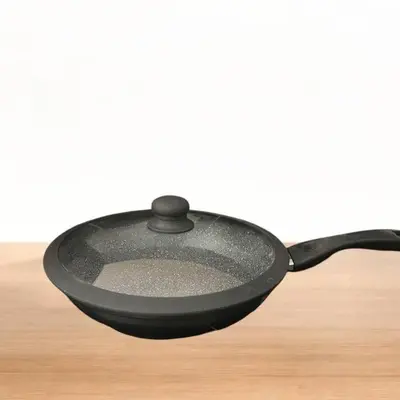 a black cast iron skillet sitting on a table at Condo in Las Piñas- The Suite Spot Alabang in Manila