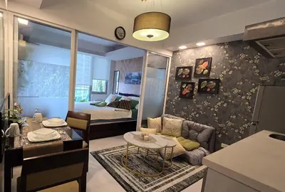 a living room with a couch and a bedroom at Urban Resort luxury Staycation at Azure Residences Rio Tower in Manila